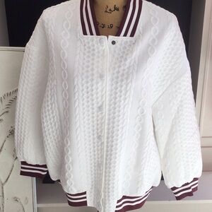 Oversized lightweight team color jacket perfect for cool mornings.